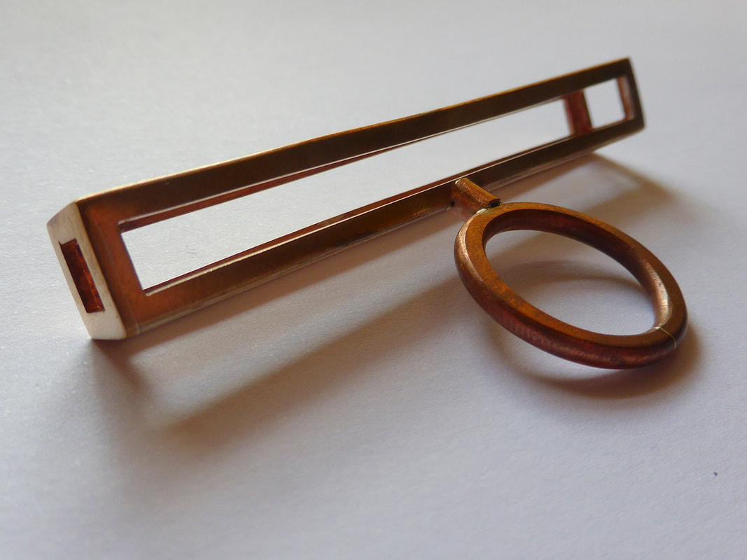 rectangular copper ring on pale background