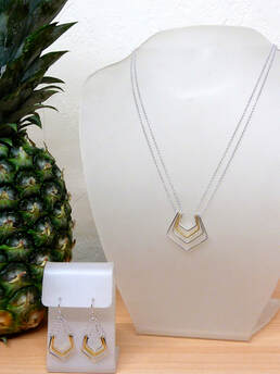long necklace with four layered strips of sterling silver and gold plate on necklace stand, matching earrings of three layers, sterling silver and gold plate with pineapple