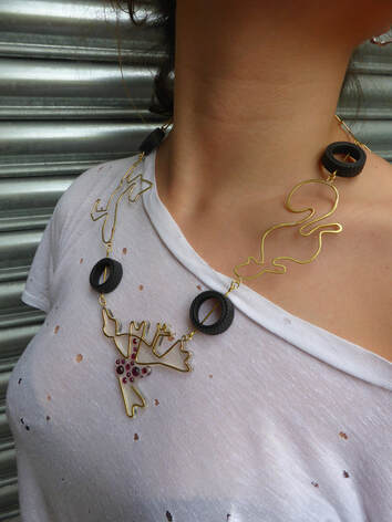 Brass, Garnet and rubber necklace on a model with white t-shirt